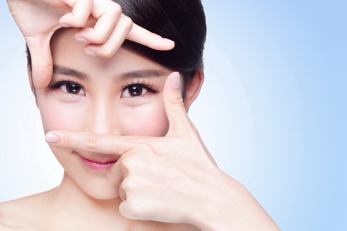 Woman face and eye care and she making frame with hands, asian beauty