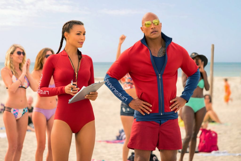 (L-R) Ilfenesh Hadera as Stephanie Holden and Dwayne Johnson as Mitch Buchannon in the film BAYWATCH by Paramount Pictures, Montecito Picture Company, FlynnPicture Co., and Fremantle Productions