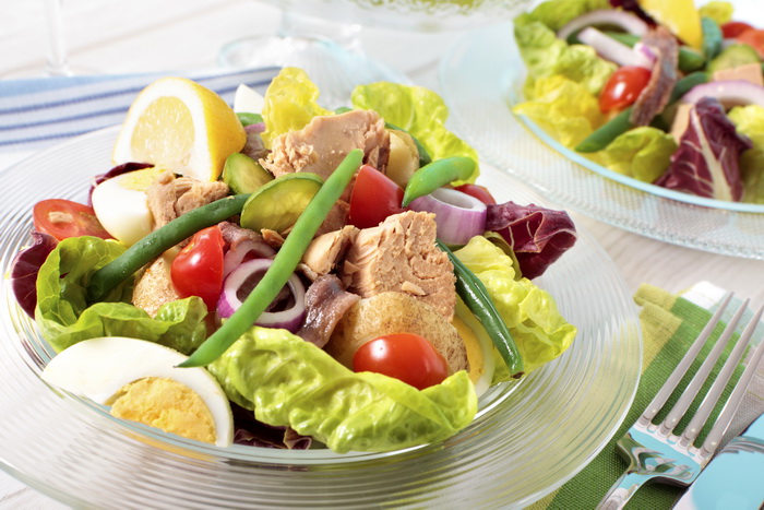 Nicioise salad arranged on table